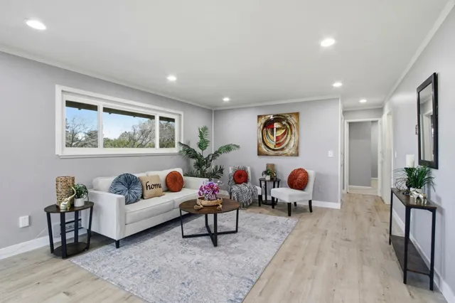 a living room with furniture and wooden floor