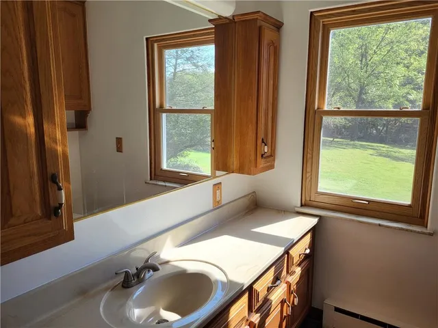 a bathroom with a sink and a window