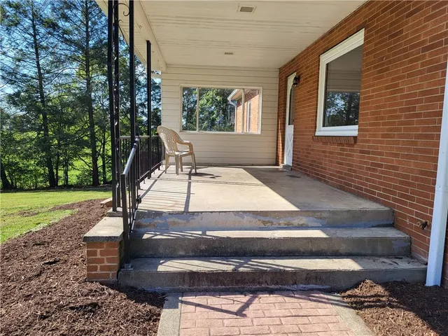 a view of yard with swimming pool and green space