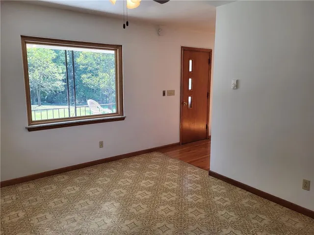 an empty room with windows and closet
