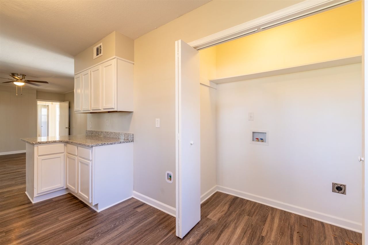 5350 Mesquite Road Memphis, TN 38120 - Photo 12 of 24 a kitchen with a refrigerator and white cabinets