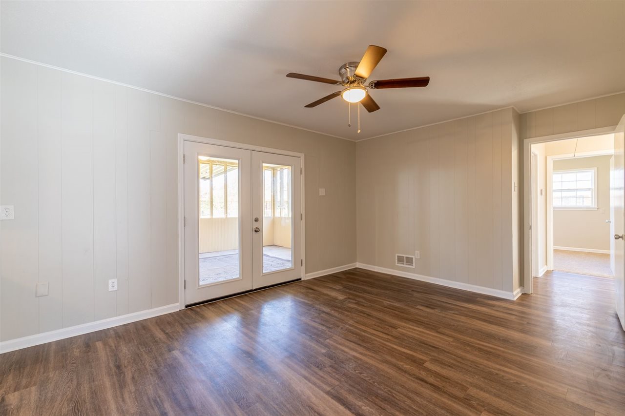 5350 Mesquite Road Memphis, TN 38120 - Photo 14 of 24 a view of an empty room with wooden floor and a window