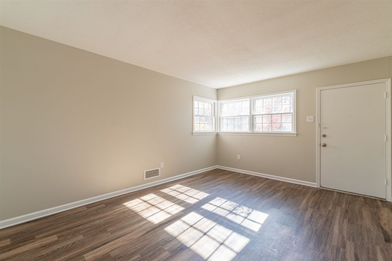 5350 Mesquite Road Memphis, TN 38120 - Photo 19 of 24 an empty room with wooden floor and windows
