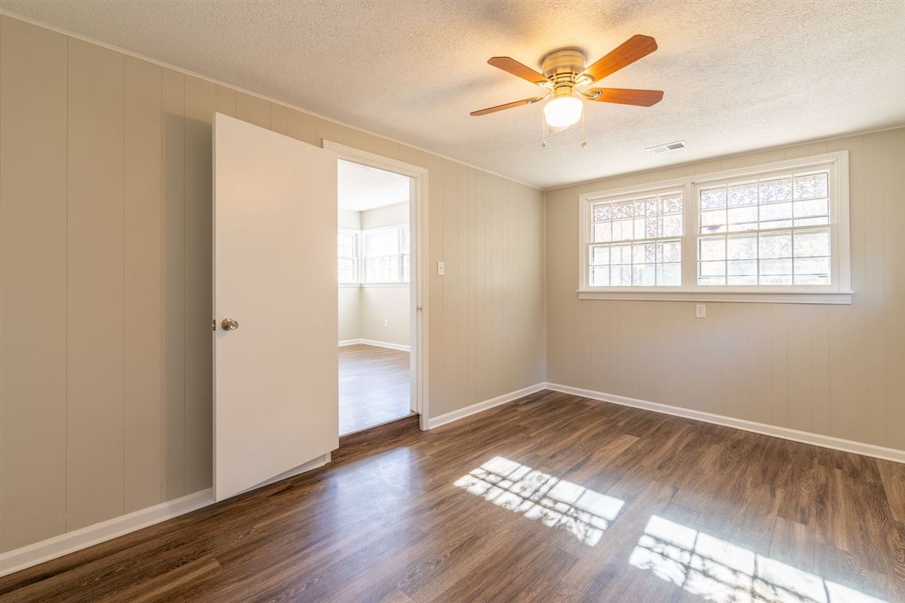 5350 Mesquite Road Memphis, TN 38120 - Photo 22 of 24 a view of an empty room with window and a chandelier fan