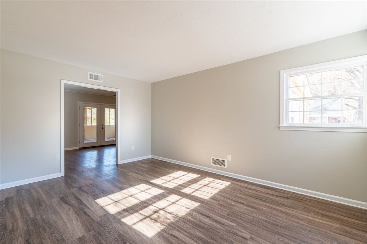 5350 Mesquite Road Memphis, TN 38120 - Photo 4 of 24 an empty room with wooden floor and windows