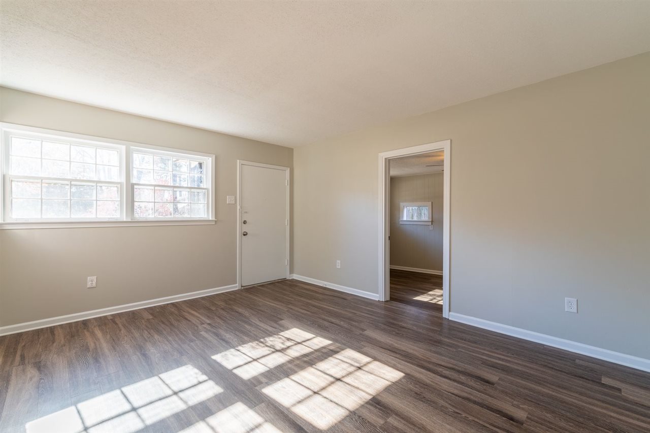 5350 Mesquite Road Memphis, TN 38120 - Photo 7 of 24 an empty room with wooden floor and windows