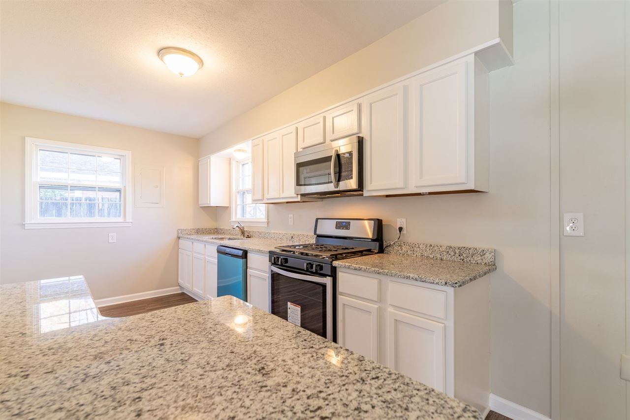 5350 Mesquite Road Memphis, TN 38120 - Photo 9 of 24 a kitchen with stainless steel appliances granite countertop a stove a sink and a microwave