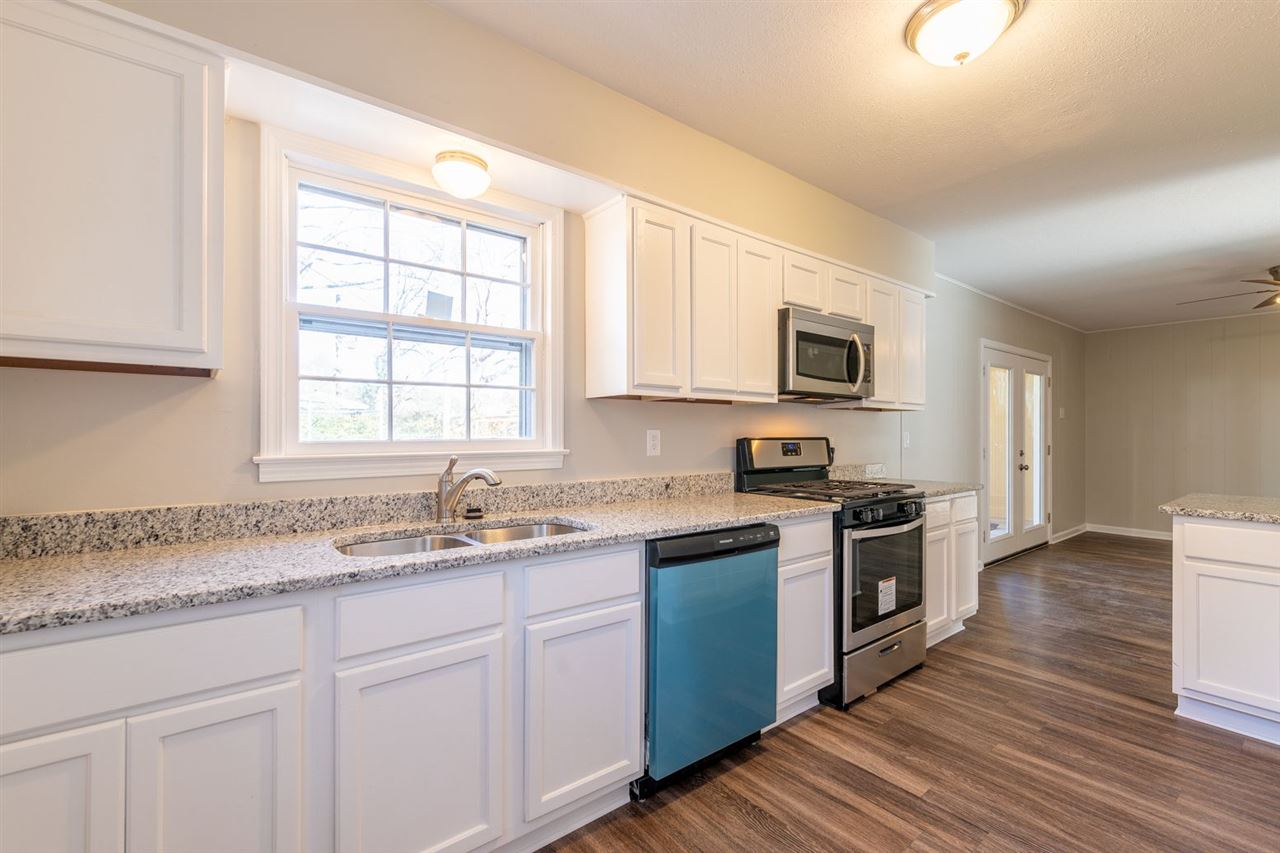 5350 Mesquite Road Memphis, TN 38120 - Photo 10 of 24 a kitchen with granite countertop cabinets stainless steel appliances a sink and a window
