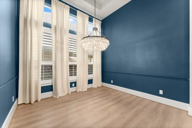a view of a hallway with wooden floor and a window