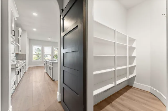 a view of a refrigerator in kitchen and a living room