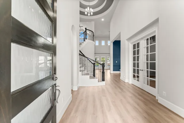 a view of a hallway with wooden floor and staircase