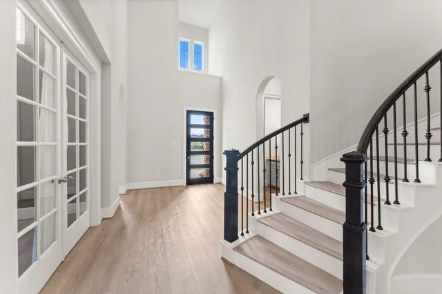 a view of staircase with white walls and a window