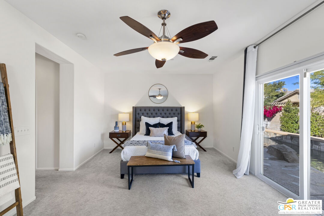 1264 Oro Ridge Palm Springs, CA 92262 - Photo 17 of 38 a bed room with a bed and a chandelier