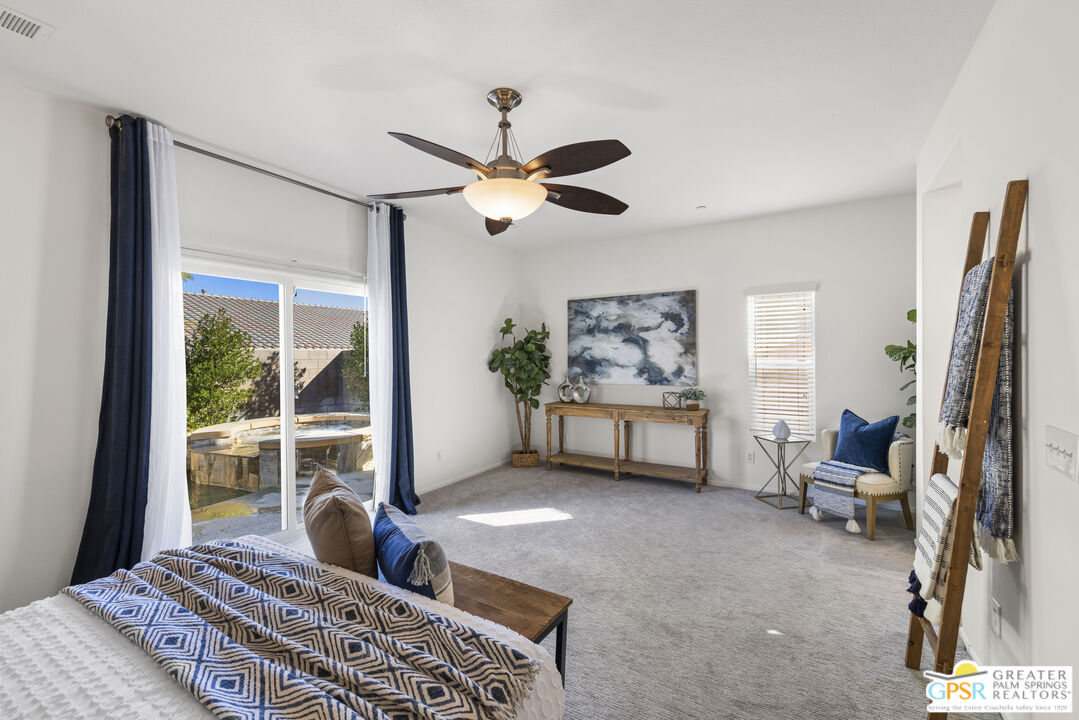 1264 Oro Ridge Palm Springs, CA 92262 - Photo 18 of 38 a living room with furniture a ceiling fan and a large window