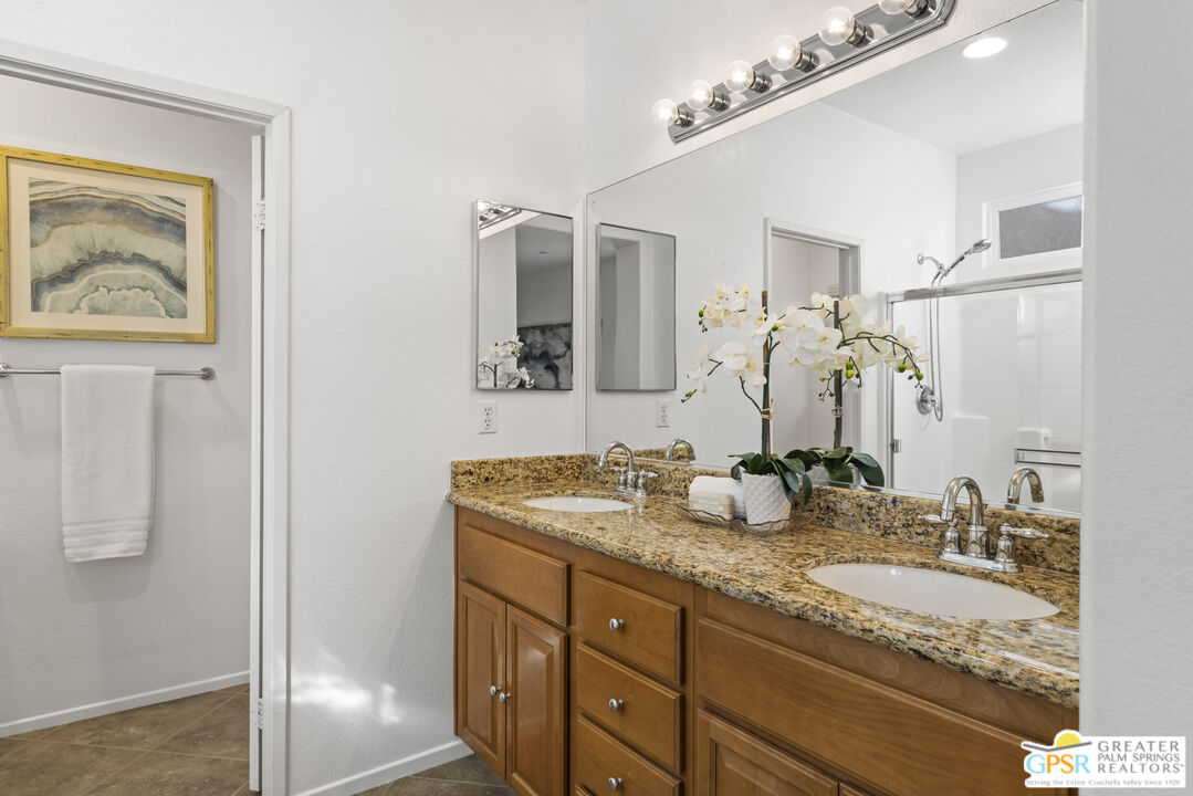 1264 Oro Ridge Palm Springs, CA 92262 - Photo 20 of 38 a bathroom with a granite countertop double vanity sink and mirror