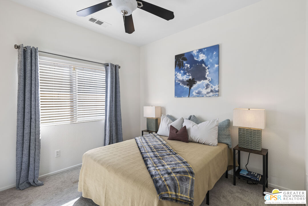 1264 Oro Ridge Palm Springs, CA 92262 - Photo 22 of 38 a bedroom with a large bed and a window