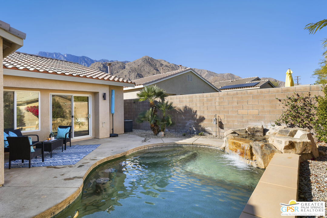 1264 Oro Ridge Palm Springs, CA 92262 - Photo 30 of 38 a swimming pool with outdoor seating
