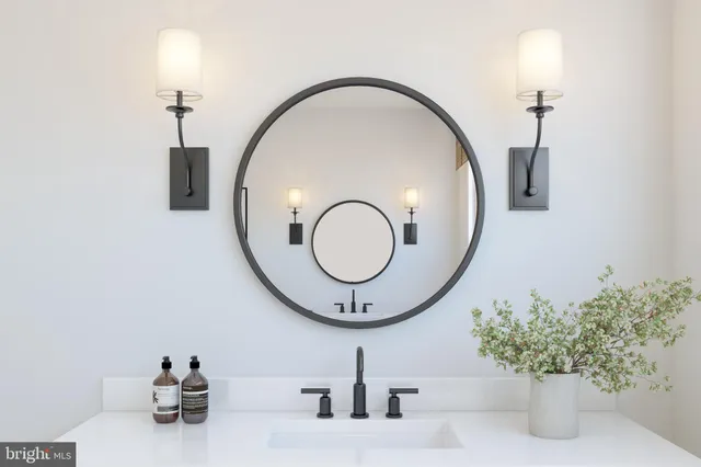 a bathroom with a sink mirror and vanity