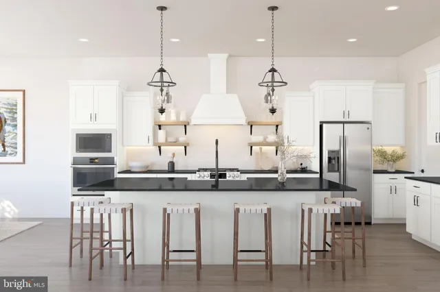 a kitchen with stainless steel appliances granite countertop a dining table chairs sink and cabinets