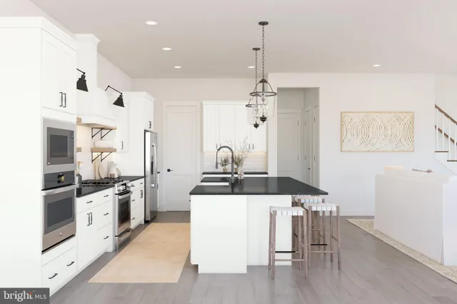 a kitchen with stainless steel appliances granite countertop a stove top oven a sink and a refrigerator