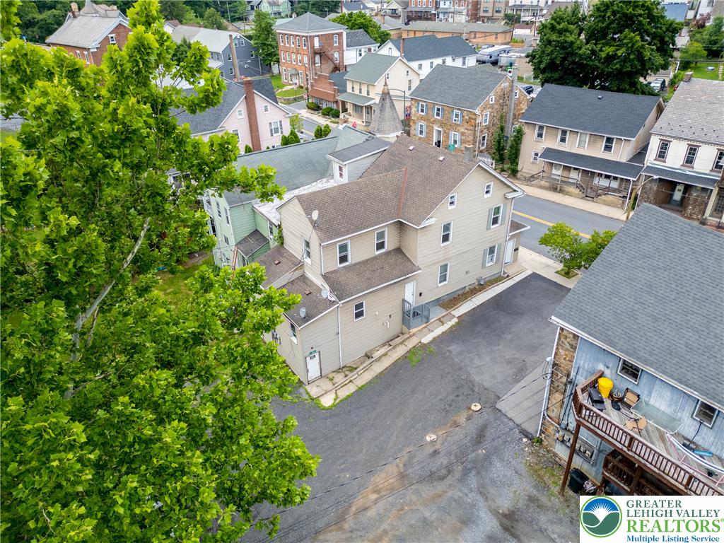 313 Main Street Slatington, PA 18080 - Photo 67 of 73 An aerial perspective reveals a residential area with diverse architecture and a backdrop of verdant trees.