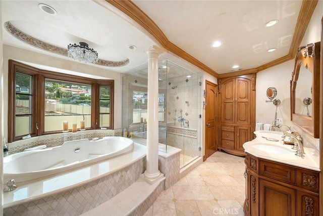 a spacious bathroom with a tub sink shower and mirror