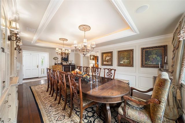 a view of a dining room with furniture and chandelier