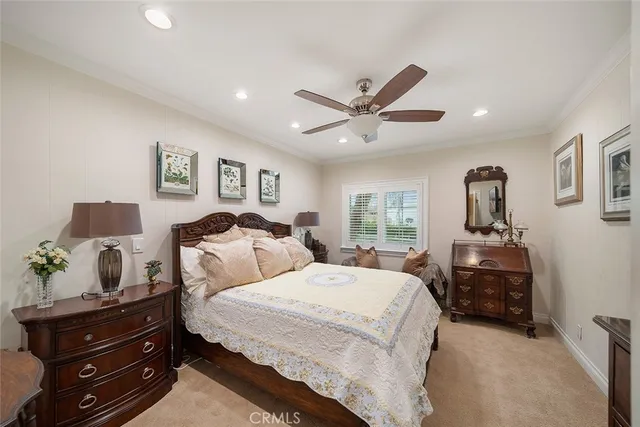 a spacious bedroom with two beds and a chandelier