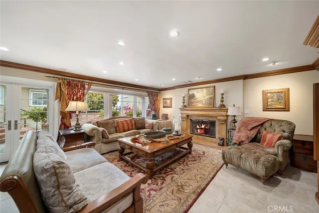 a living room with fireplace furniture and a large window