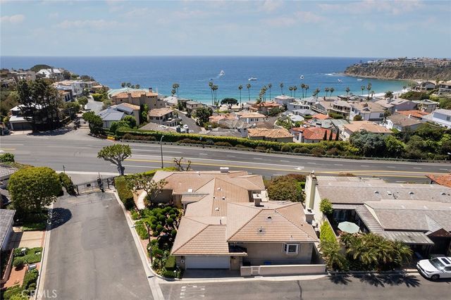 an aerial view of a house with yard and mountain view in back