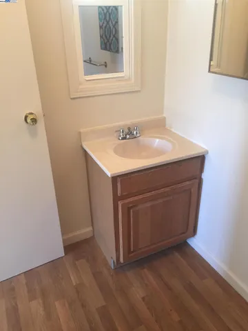 a utility room with a sink a mirror and vanity