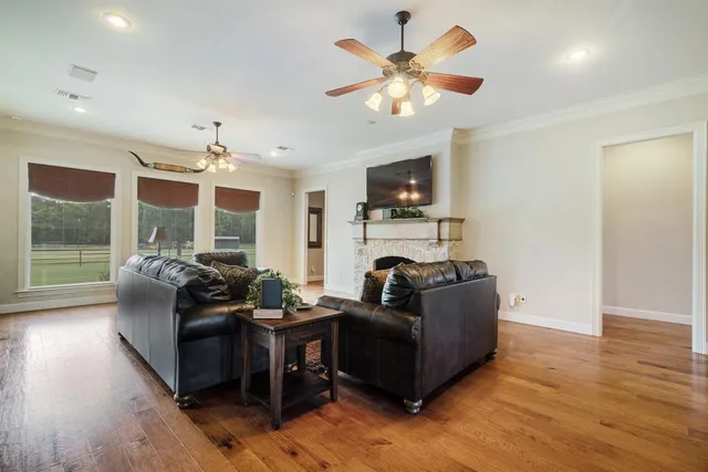 a living room with fireplace furniture and a flat screen tv
