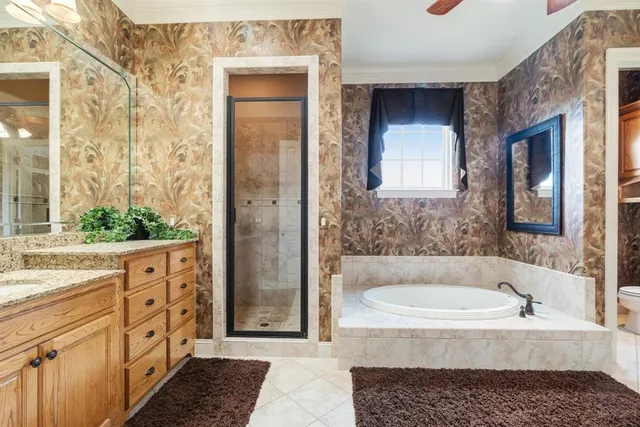 a bathroom with a bathtub a double vanity sink and a mirror