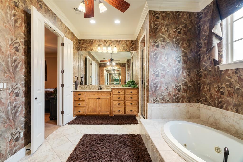 5500 Farm Road 195 Paris, TX 75462 - Photo 20 of 40 a bathroom with a bathtub a double vanity sink and a mirror