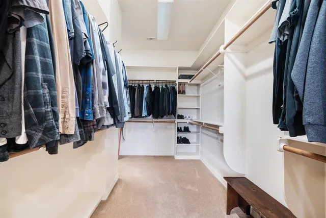 a bathroom with a granite countertop toilet sink and mirror