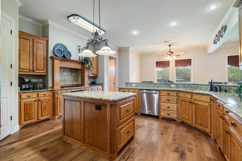 5500 Farm Road 195 Paris, TX 75462 - Photo 7 of 40 a kitchen with granite countertop a sink a stove cabinets and wooden floor