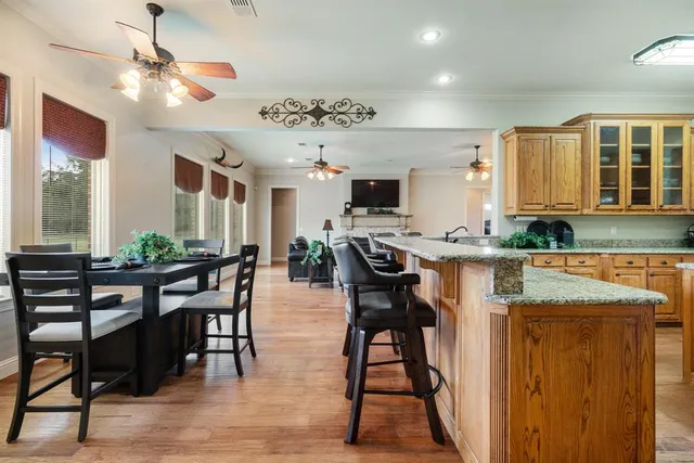 a view of a a dining room with furniture window and wooden floor
