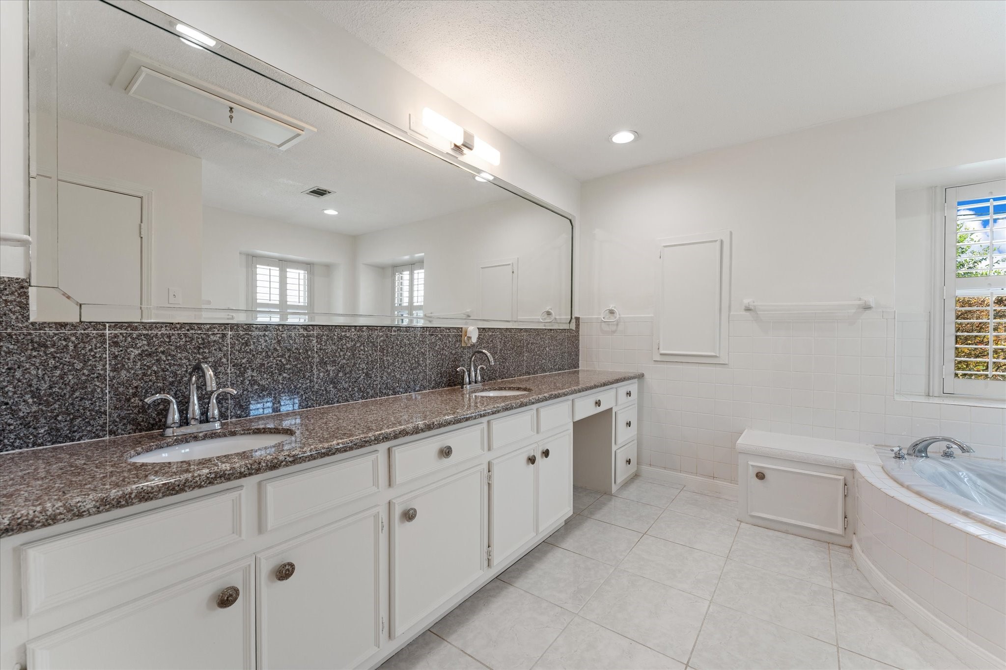 983 West Donovan Street Houston, TX 77091 - Photo 21 of 46 Primary Ensuite view 1 with double sinks with vanity and plenty of counter space and cabinets