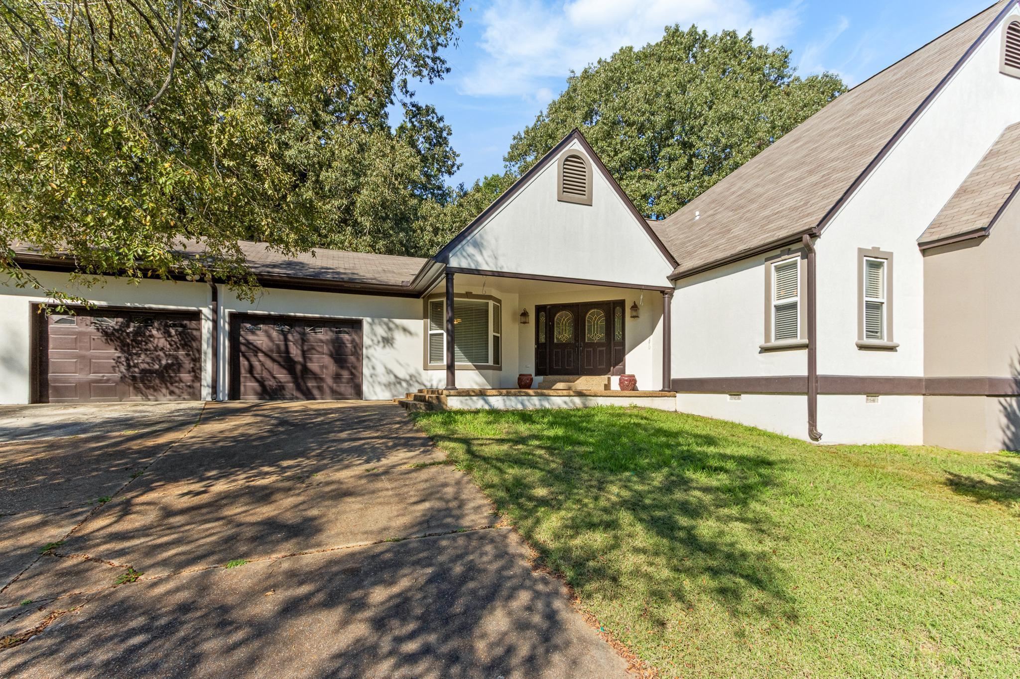 380 Woodbridge Road Somerville, TN 38068 - Photo 1 of 30 View of front facade featuring crawl space, driveway, a front yard, covered porch, and a garage