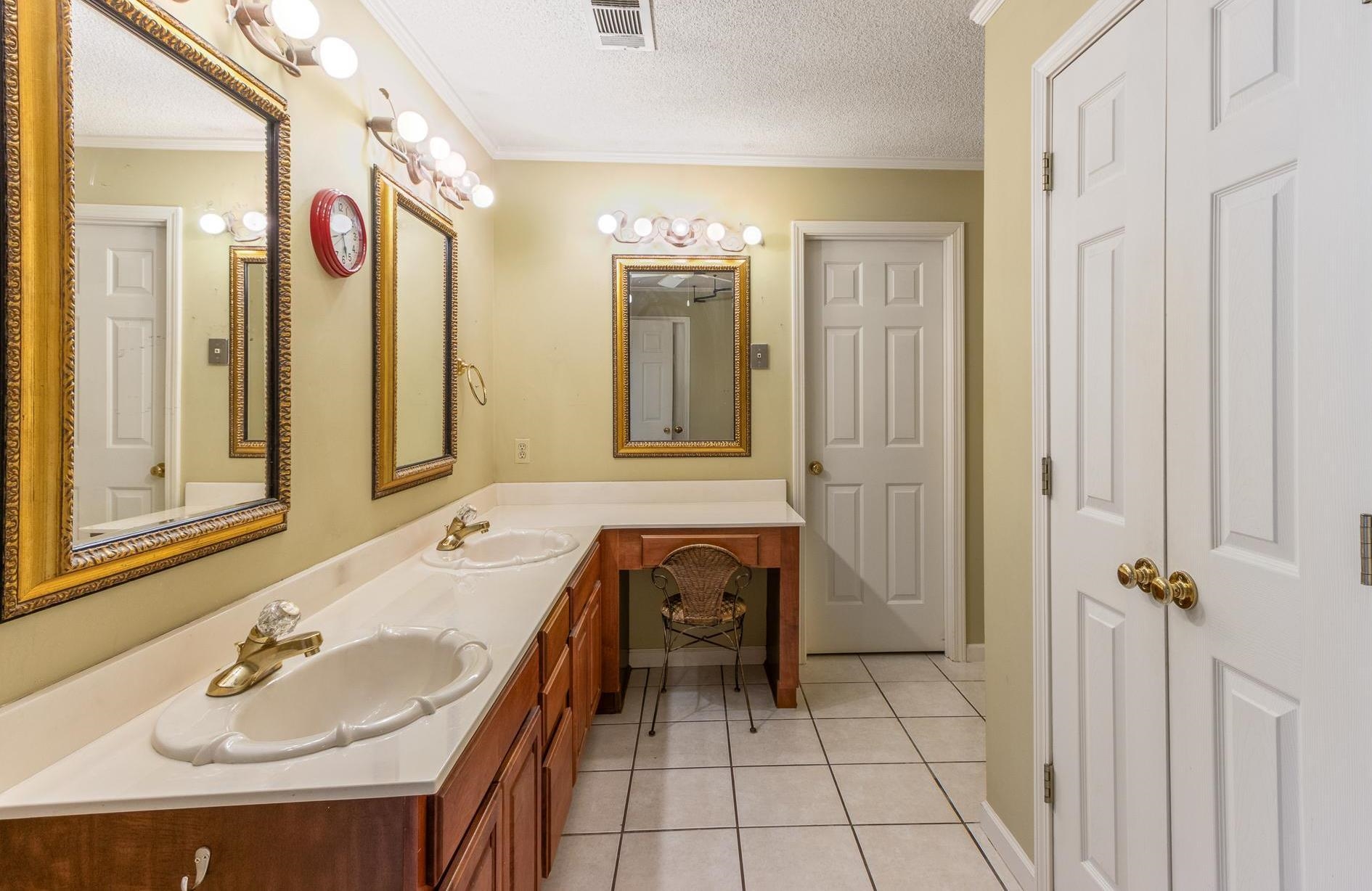 380 Woodbridge Road Somerville, TN 38068 - Photo 16 of 30 Full bathroom with light tile patterned floors, a textured ceiling, double vanity, and crown molding
