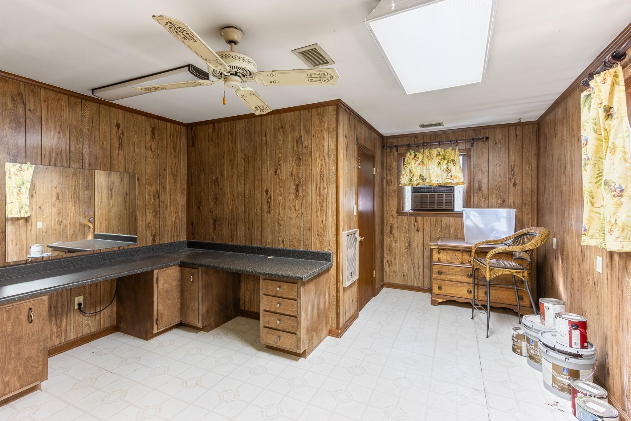 380 Woodbridge Road Somerville, TN 38068 - Photo 25 of 30 Office area featuring light floors, wooden walls, a ceiling fan, heating unit, and built in desk