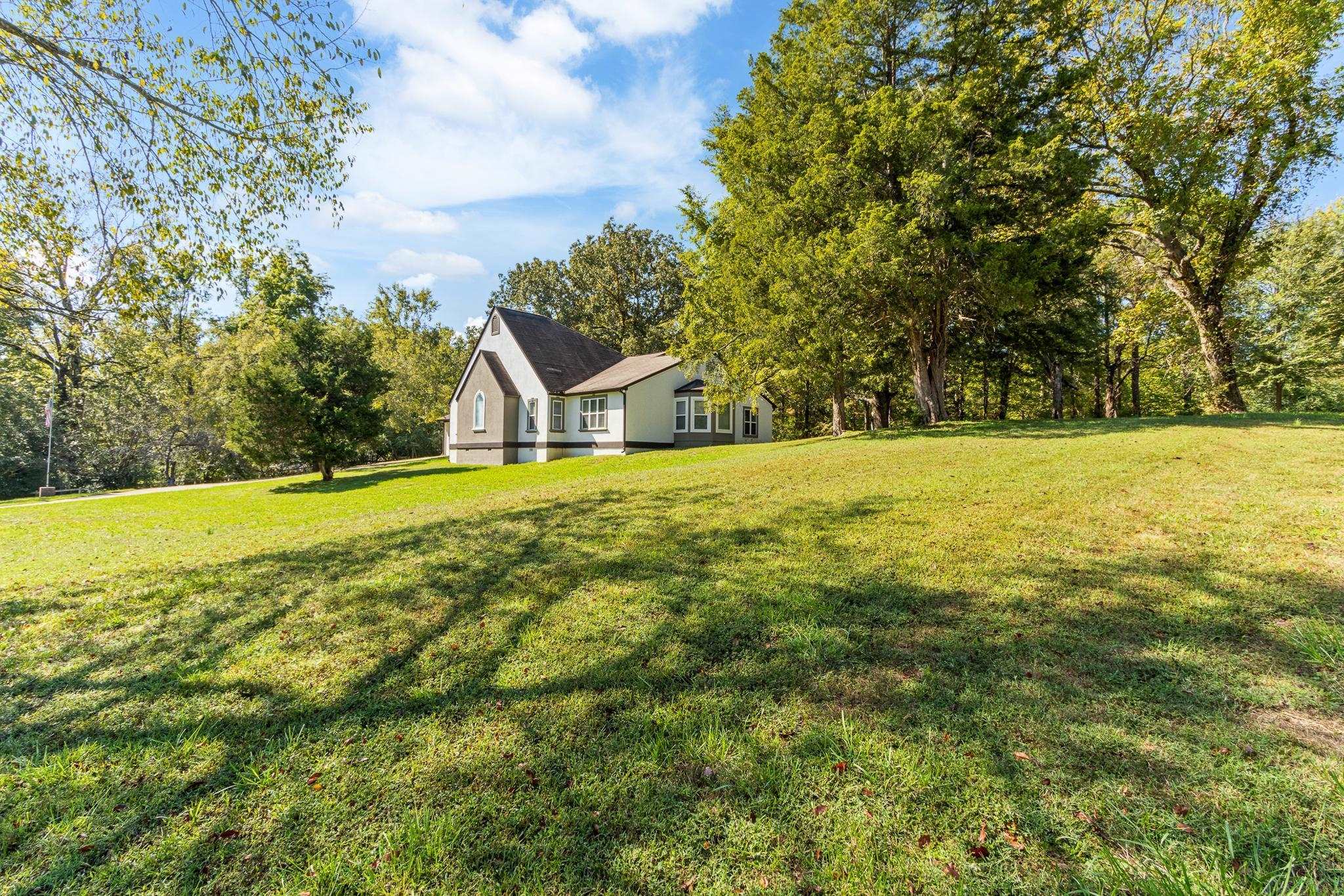 380 Woodbridge Road Somerville, TN 38068 - Photo 3 of 30 View of green lawn with view of scattered trees