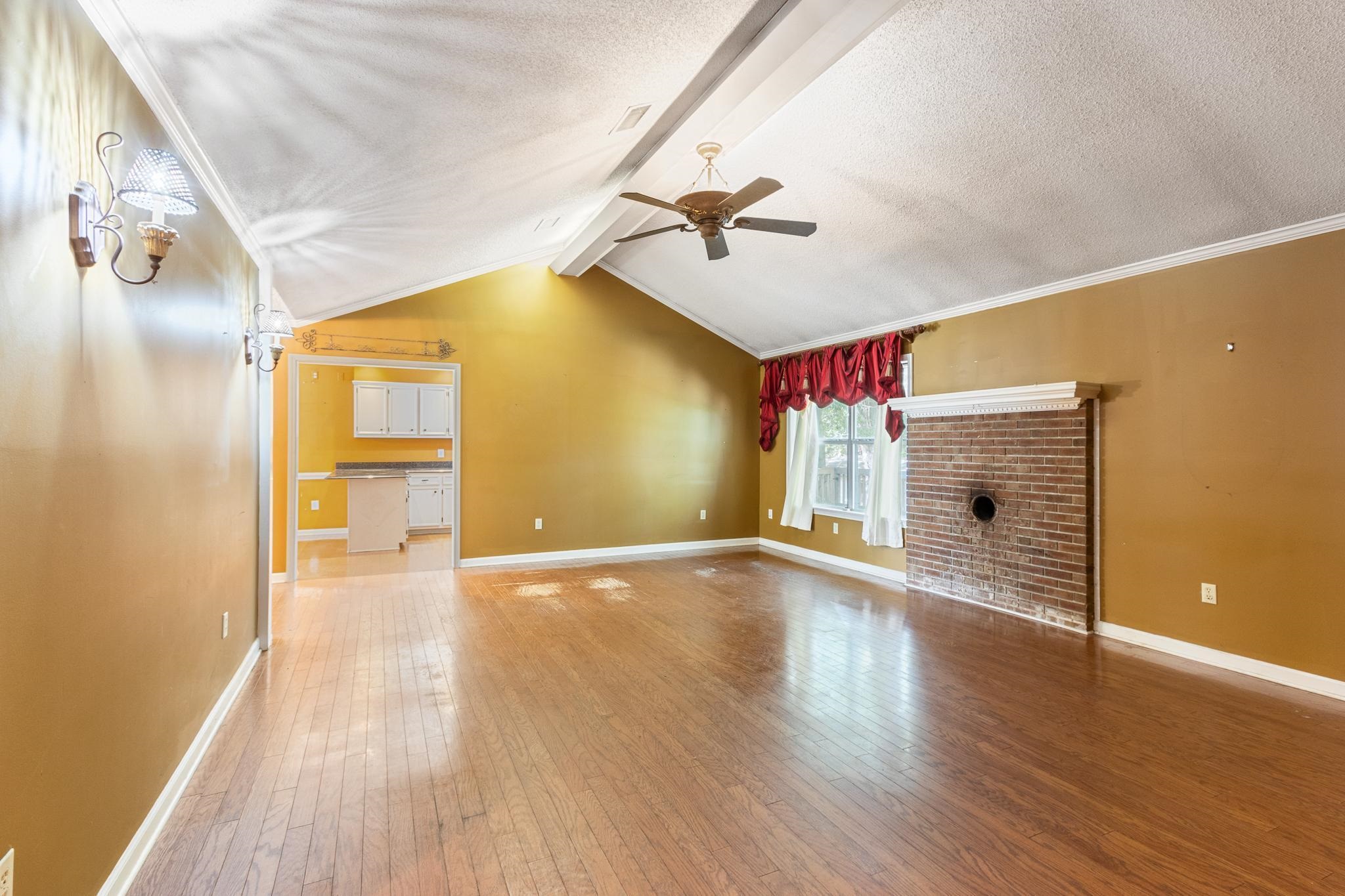 380 Woodbridge Road Somerville, TN 38068 - Photo 7 of 30 Unfurnished living room with light wood finished floors, a textured ceiling, and ceiling fan