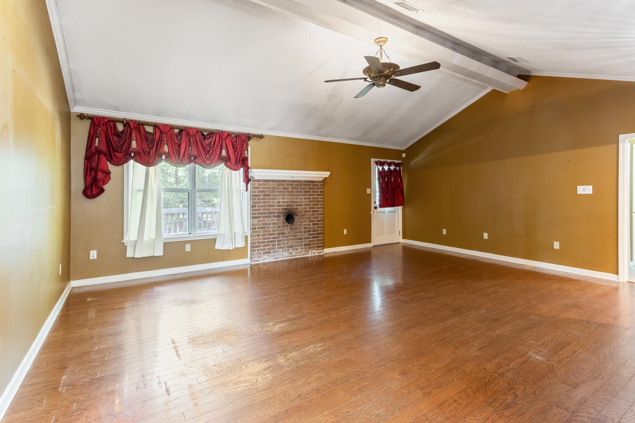 380 Woodbridge Road Somerville, TN 38068 - Photo 8 of 30 Unfurnished living room featuring a ceiling fan and light wood-style floors