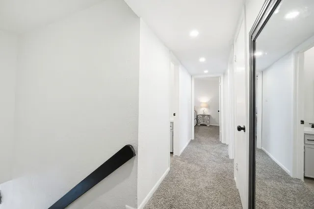 a view of a hallway with white walls