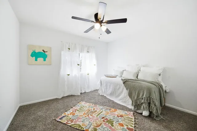 a bed room with a bed and a window