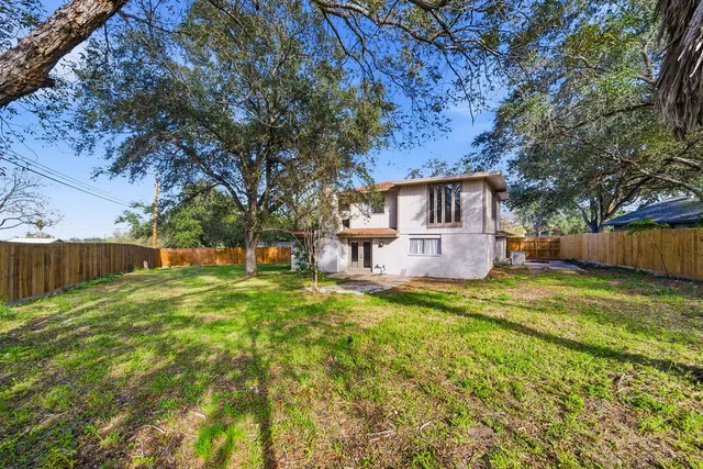 a backyard of a house with table and chairs