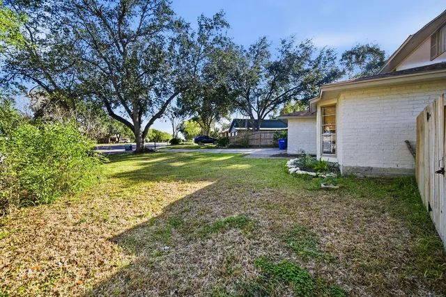 a view of a house with a yard and tree s