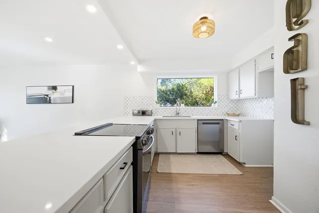 a utility room with cabinets washer and dryer
