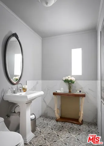 a bedroom with bed and a chandelier